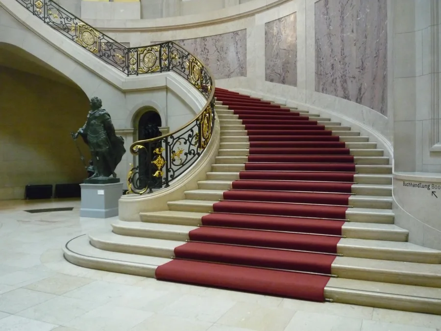 The curved staircase beneath the great dome of the Bode-Museum, Berlin. Architectural reference, not a project of the House.